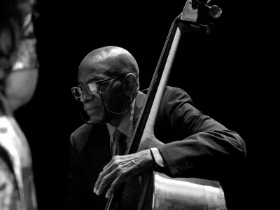 Reggie Workman plays an upright bass