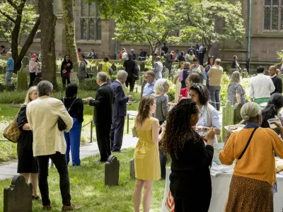 Trinity parishioners gathering for a picnic in the Trinity Churchyard