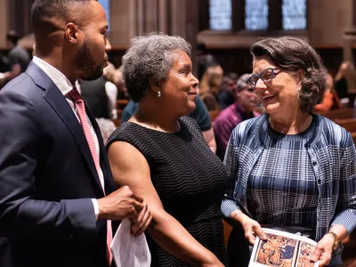 Three parishioners chat before a Sunday service in Trinity Church.