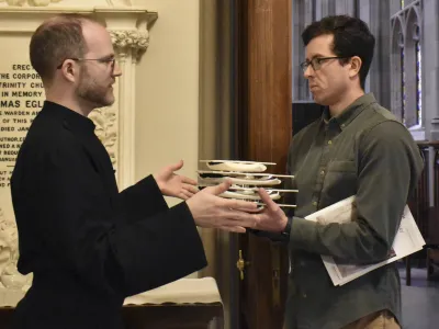 Assistant Head Sacristan Dane Miller works with a worship leader volunteer