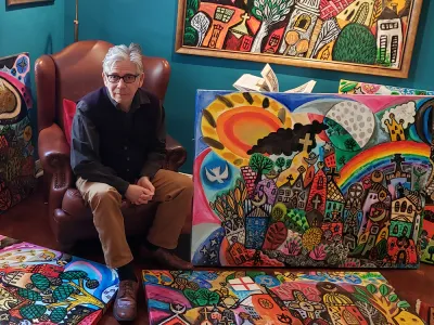 Brian Whelan with his paintings