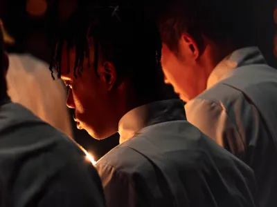 People pray in front of candle light