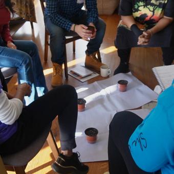 Who Keeps the Keeper program participants sit in a circle in group discussion at the Trinity Retreat Center.