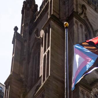 The pride flag with the church in the background. 