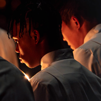 People pray in front of candle light