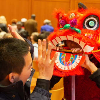 A child wears a lion mask at Trinity's Lunar New Year celebration.