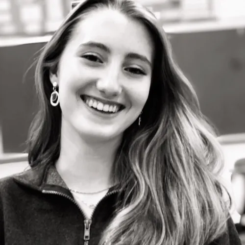 Black and white shot of Taylor Elliot smiling directly into the camera.