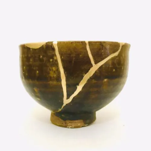 Broken ceramic bowl mended with gold