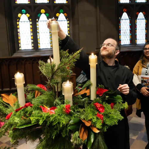 Dane Miller lights Advent candles in Trinity Church