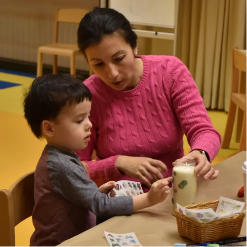 A kid and a parent have a workshop