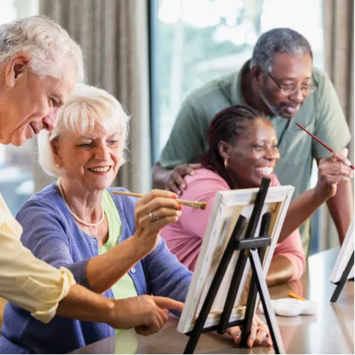 A pair of senior couples paint.