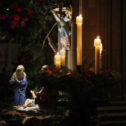 Jesus's birth figurines next to candles.