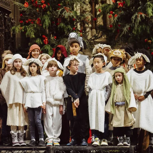 Kids line up at the altar in costumes.