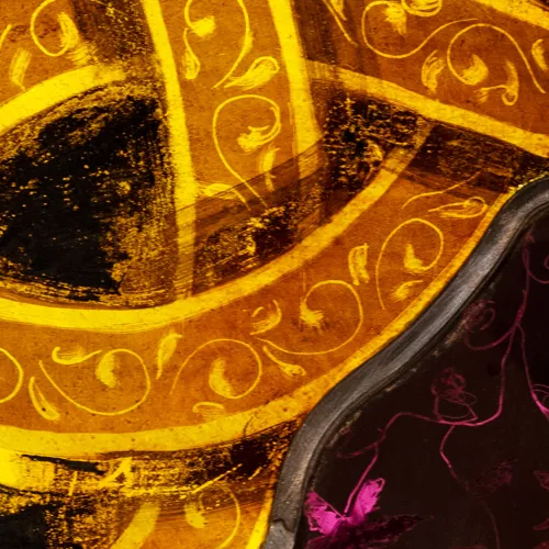 Detailed close-up photo of stained-glass window in Trinity Church featuring gold swirls and violet tendrils