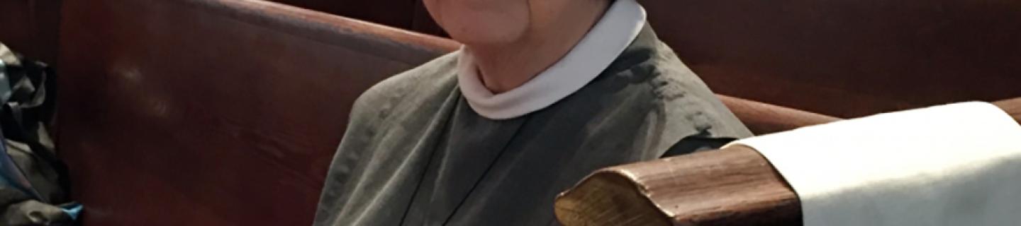 Sister Ann Whittaker sits in a pew at Trinity Church